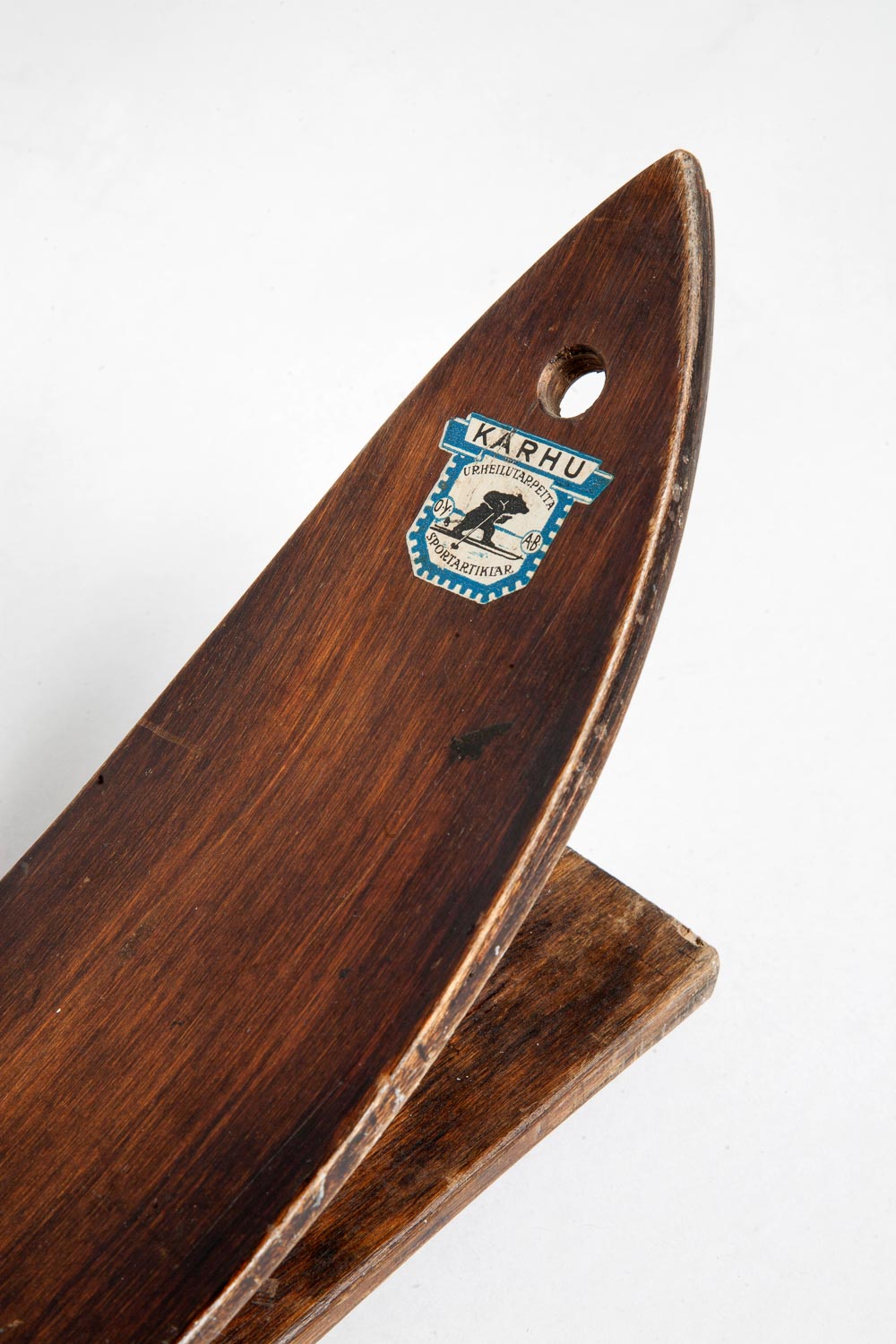 The tip of a wooden ski.